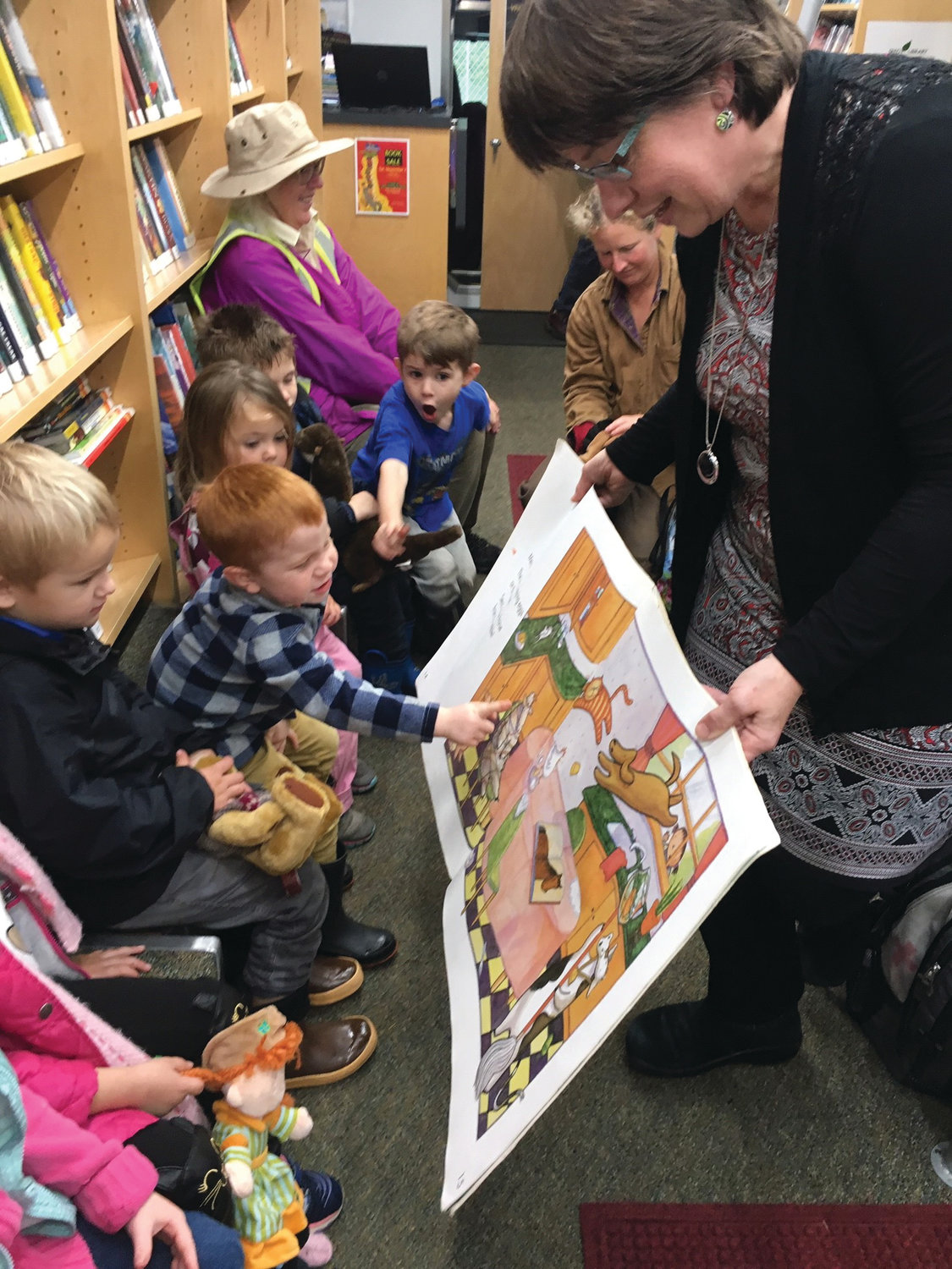 Jefferson County Library Mobile Services Manager Celeste Bennett reading to the “story time” class during the Quilcene Preschool’s weekly bookmobile visit Oct. 22.